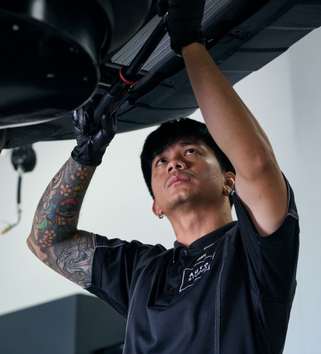Auto Studio team member using premium equipment