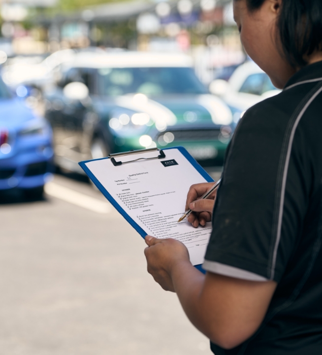 Auto Studio team member completing paperwork