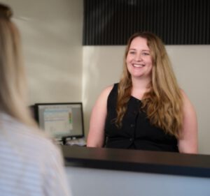Auto Studio team member greeting a customer at reception